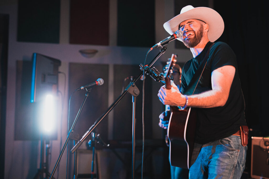 Featured: Country Artist Kyle Elliott performing on stage.